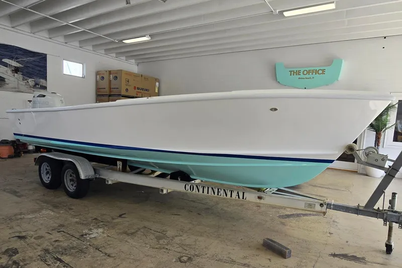 The Image of 2027 Albury Brothers 23 boat on a trailer in a garage. - 0