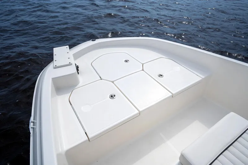 Slide: The Image of Manufacturer Provided Image: 2025 Bayliner Trophy T18 boat deck with storage compartments on calm water. - 2