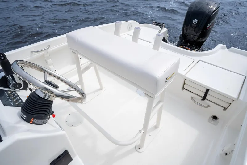 Slide: The Image of Manufacturer Provided Image: 2025 Bayliner Trophy T18 boat interior with steering wheel and seating, on open water. - 3