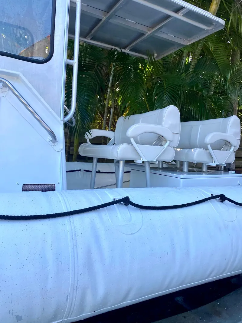 Slide: The Image of 2001 Willard 25 boat with white seating and canopy. - 9