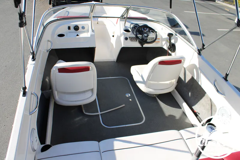 Slide: The Image of Interior of a 2015 Bayliner 170 boat with white seating. - 10