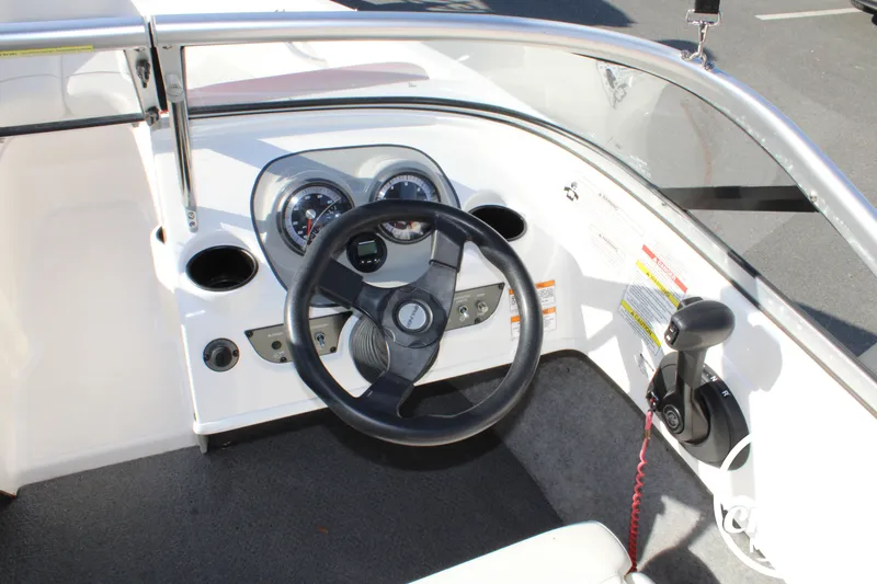 Slide: The Image of 2015 Bayliner 170 boat steering console with wheel and gauges. - 12