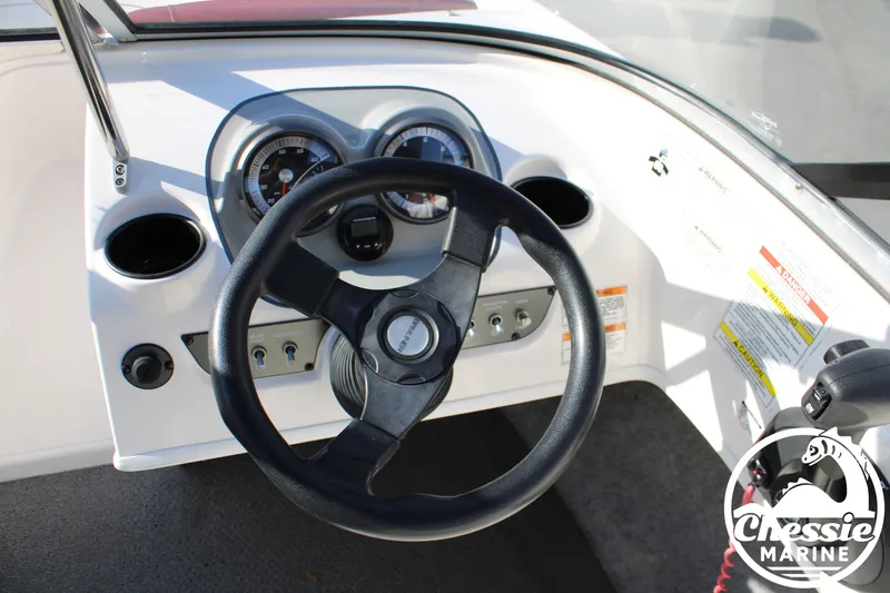 Slide: The Image of Steering wheel and dashboard of a 2015 Bayliner 170 boat. - 13