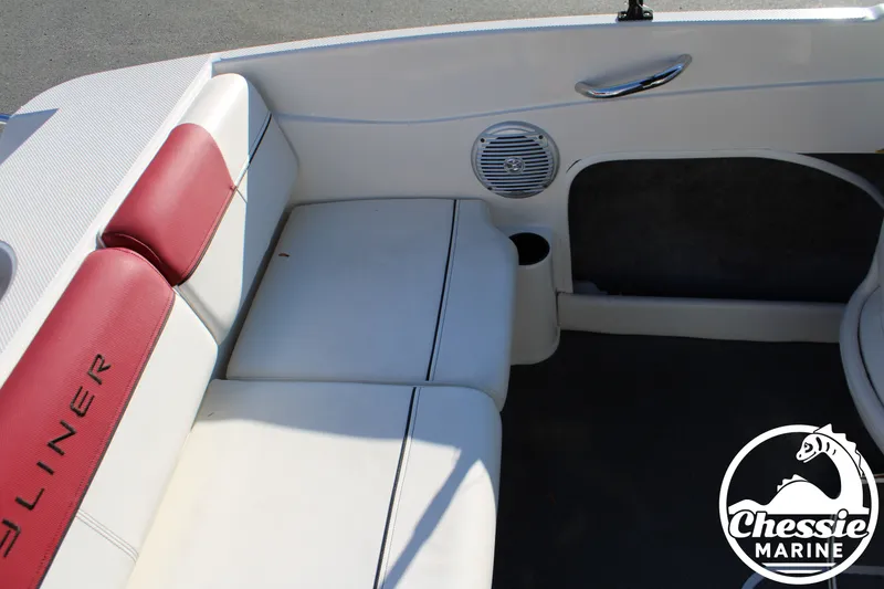 Slide: The Image of Interior of a 2015 Bayliner 170 boat with red and white seating. - 17