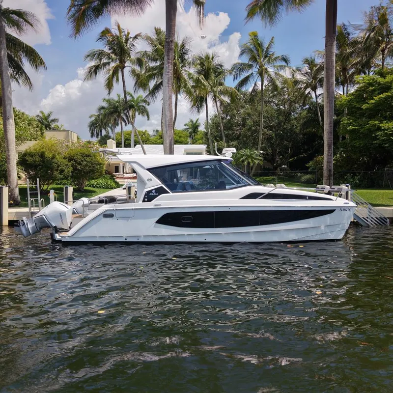 The Image of Aquila 36 Sport 2025 on water with tropical backdrop. - 0