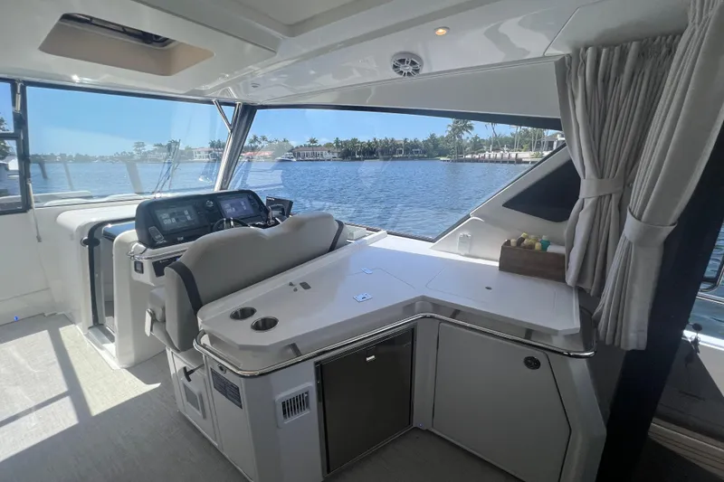 Slide: The Image of Interior of 2025 Aquila 36 Sport yacht with modern helm and scenic water view. - 16
