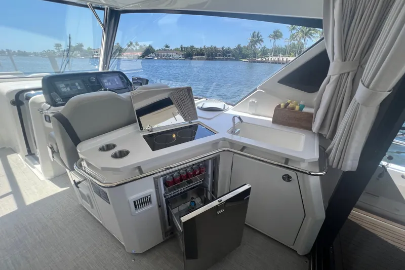 Slide: The Image of Luxurious interior of 2025 Aquila 36 Sport yacht with kitchenette and scenic water view. - 17