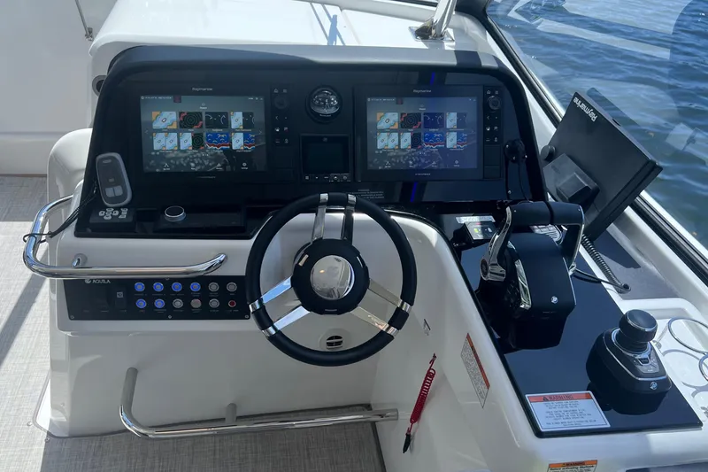 Slide: The Image of Helm of 2025 Aquila 36 Sport boat with advanced navigation displays and controls. - 22