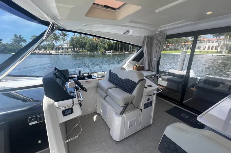 Slide: The Image of Interior of 2025 Aquila 36 Sport yacht with luxurious seating and scenic water view. - 23