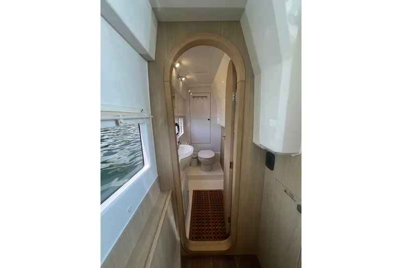 Slide: The Image of Interior of 2025 Aquila 36 Sport yacht, featuring a modern bathroom with wooden accents. - 26