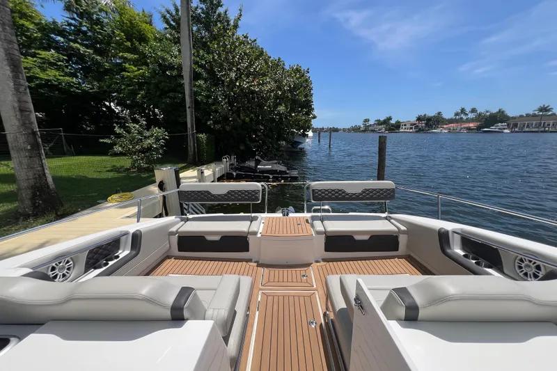 Slide: The Image of Aquila 36 Sport 2025 boat with luxurious seating and scenic waterfront view. - 30