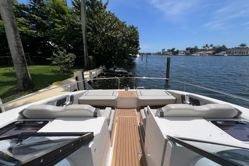 Slide: The Image of Aquila 36 Sport 2025 yacht docked by a scenic waterfront under clear blue skies. - 31