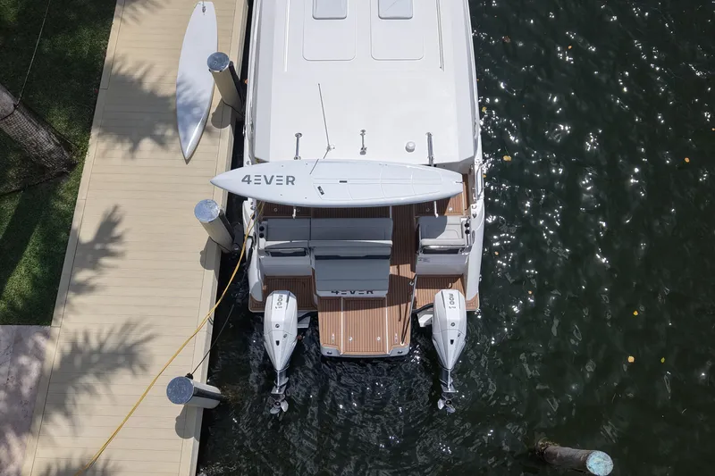 Slide: The Image of Aquila 36 Sport 2025 docked with paddleboard, aerial view. - 8