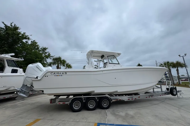 Slide: The Image of 2026 Caymas 34 CT boat on trailer, overcast sky background. - 10
