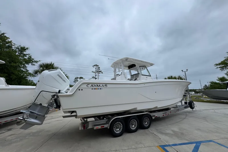 Slide: The Image of 2026 Caymas 34 CT boat on trailer, featuring sleek design and powerful Mercury outboard engine. - 11