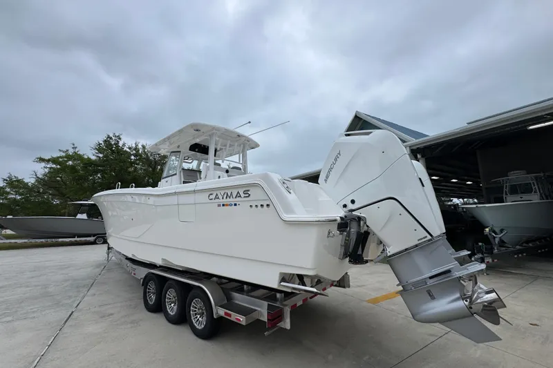 Slide: The Image of 2026 Caymas 34 CT boat on trailer with Mercury outboard engines. - 15
