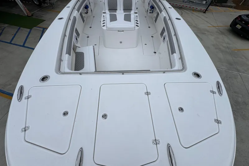 Slide: The Image of 2026 Caymas 34 CT boat deck with seating and storage compartments. - 17