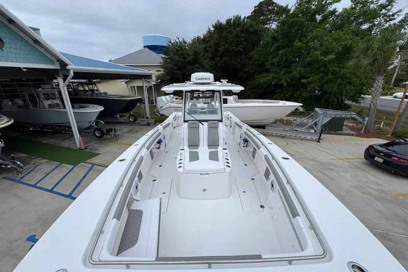 Slide: The Image of 2026 Caymas 34 CT boat docked at a marina, showcasing spacious deck and modern design. - 18