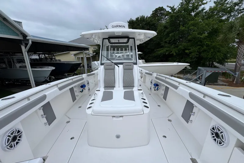 Slide: The Image of 2026 Caymas 34 CT boat interior with seating and Garmin equipment. - 19