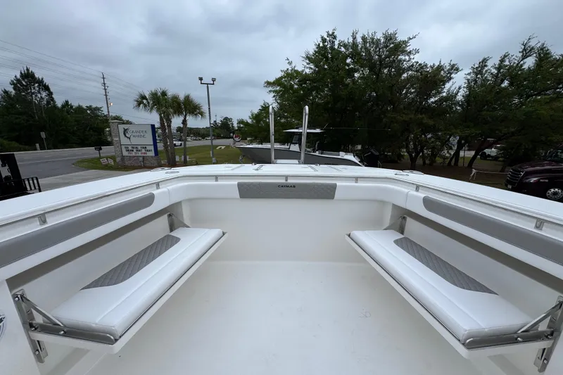 Slide: The Image of 2026 Caymas 34 CT boat interior with white seating and overcast sky. - 21