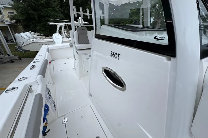 Slide: The Image of 2026 Caymas 34 CT boat interior, featuring sleek white design and modern seating. - 24
