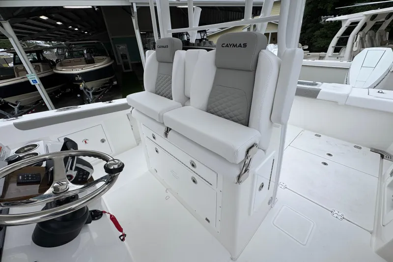 Slide: The Image of 2026 Caymas 34 CT boat interior with dual seats and steering wheel. - 26