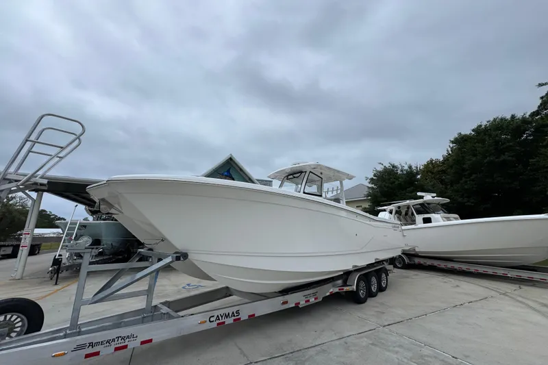 Slide: The Image of 2026 Caymas 34 CT boat on trailer, overcast sky, parked outdoors. - 3