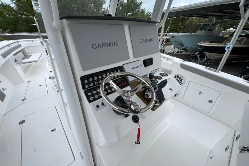 Slide: The Image of 2026 Caymas 34 CT boat cockpit with Garmin navigation system and steering wheel. - 30