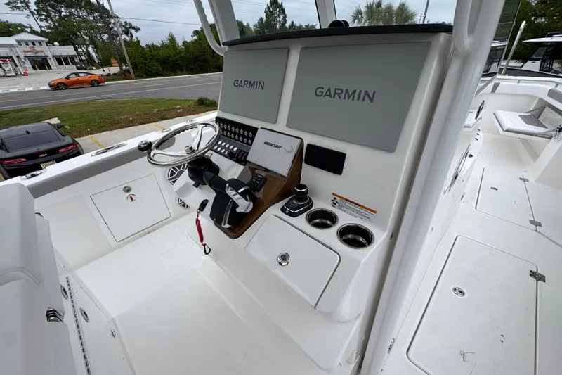 Slide: The Image of 2026 Caymas 34 CT boat helm with Garmin displays and steering wheel. - 32