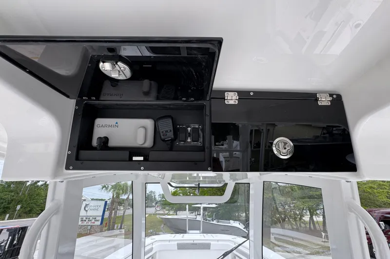 Slide: The Image of Interior view of 2026 Caymas 34 CT boat with Garmin equipment and storage compartments. - 33