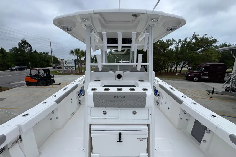 Slide: The Image of 2026 Caymas 34 CT boat interior with modern helm and seating, parked outdoors. - 35