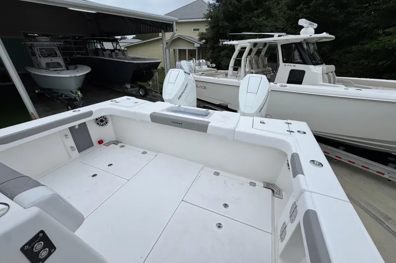 Slide: The Image of 2026 Caymas 34 CT boat with spacious deck and twin Mercury engines. - 38