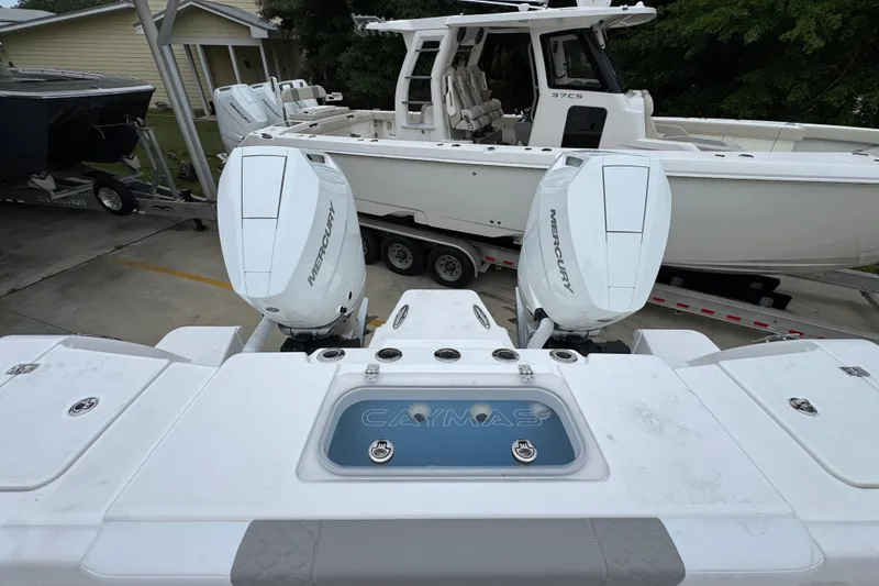 Slide: The Image of 2026 Caymas 34 CT boat with dual Mercury engines, parked on a trailer. - 40