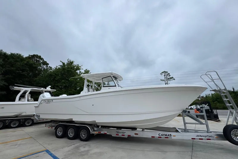 Slide: The Image of 2026 Caymas 34 CT boat on trailer, parked outdoors under cloudy sky. - 8