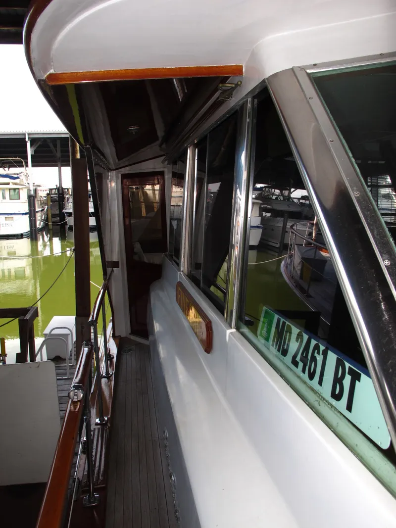 Slide: The Image of 1971 Chris-Craft 57 Constellation yacht docked, side view. - 10