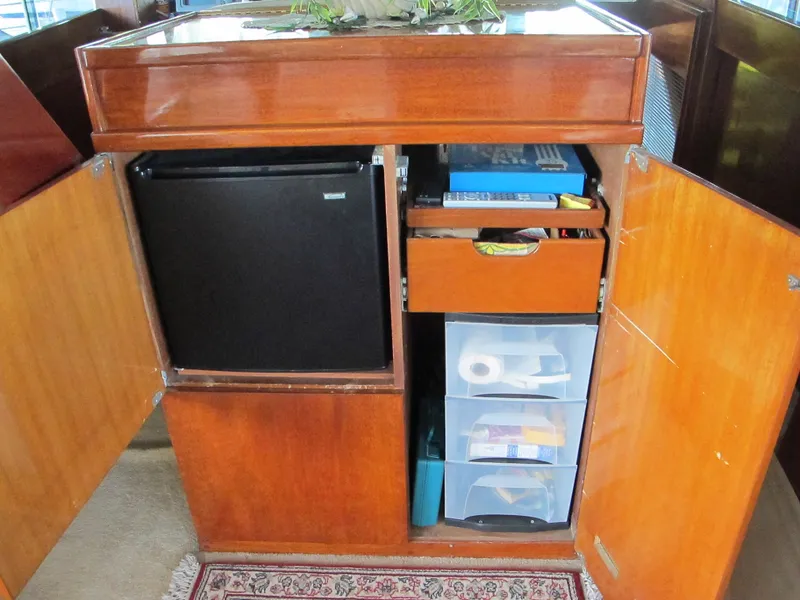 Slide: The Image of 1971 Chris-Craft 57 Constellation interior cabinet with fridge and storage. - 16