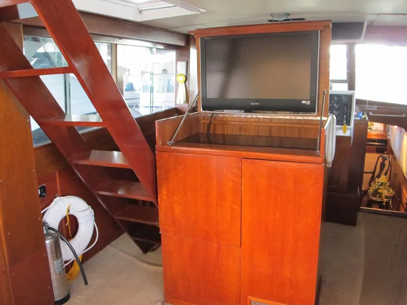 Slide: The Image of Interior of 1971 Chris-Craft 57 Constellation yacht with wooden stairs and TV. - 17