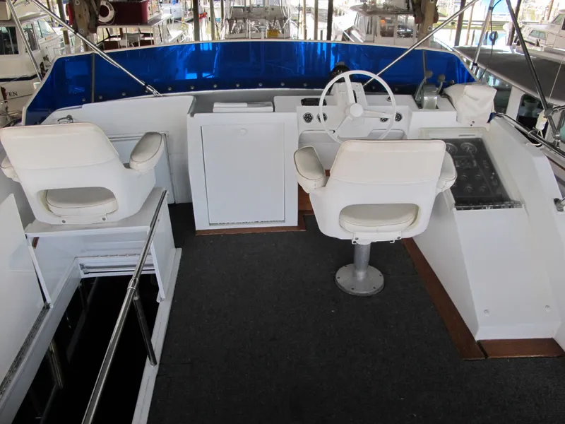 Slide: The Image of 1971 Chris-Craft 57 Constellation yacht cockpit with white seats. - 20