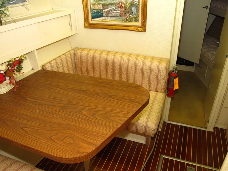 Slide: The Image of 1971 Chris-Craft 57 Constellation interior with wooden table and striped seating. - 32