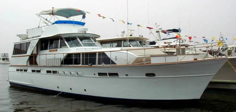 Slide: The Image of 1971 Chris-Craft 57 Constellation yacht docked with colorful flags. - 5