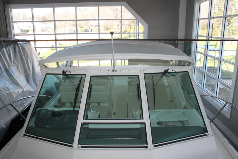 The Image of 1998 Tiara Yachts 2900 Coronet in a showroom, showcasing its sleek design and spacious interior. - 0