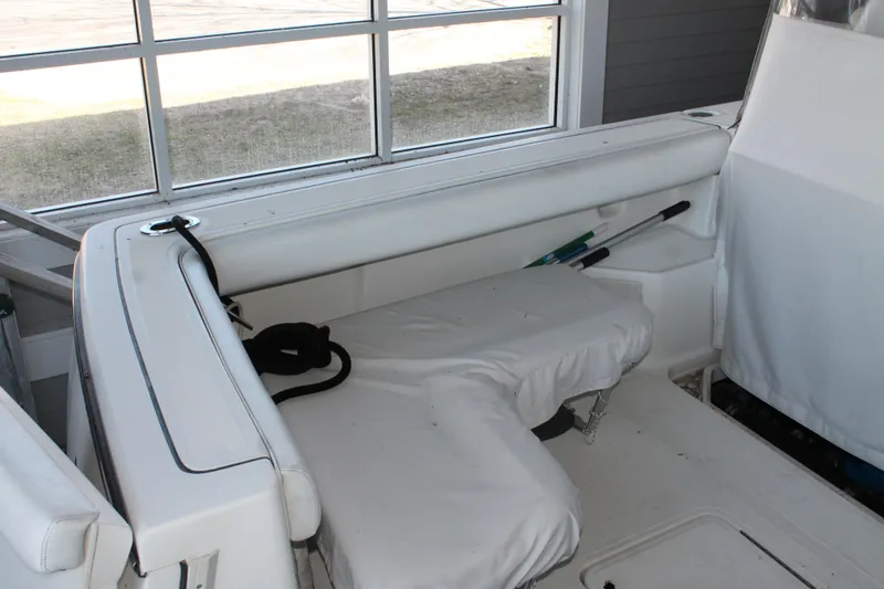 Slide: The Image of 1998 Tiara Yachts 2900 Coronet interior with white seating and window view. - 10