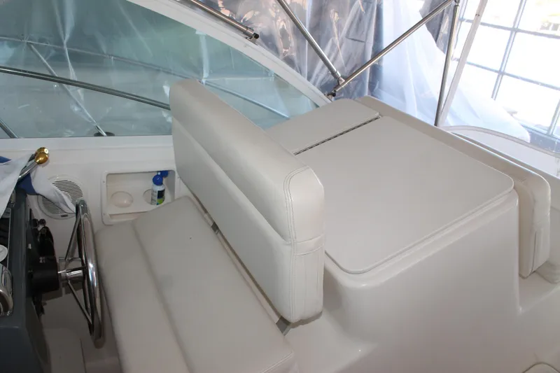 Slide: The Image of 1998 Tiara Yachts 2900 Coronet helm with white seating and steering wheel. - 12
