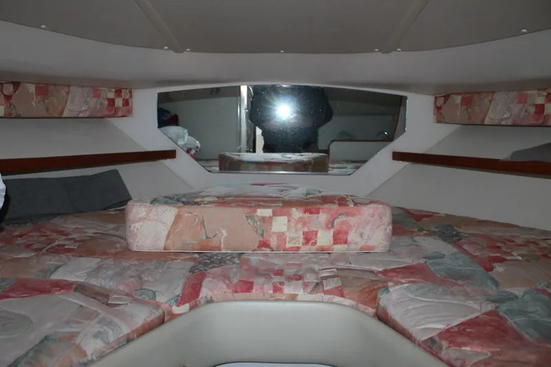 Slide: The Image of 1998 Tiara Yachts 2900 Coronet cabin interior with patterned upholstery and cozy sleeping area. - 19