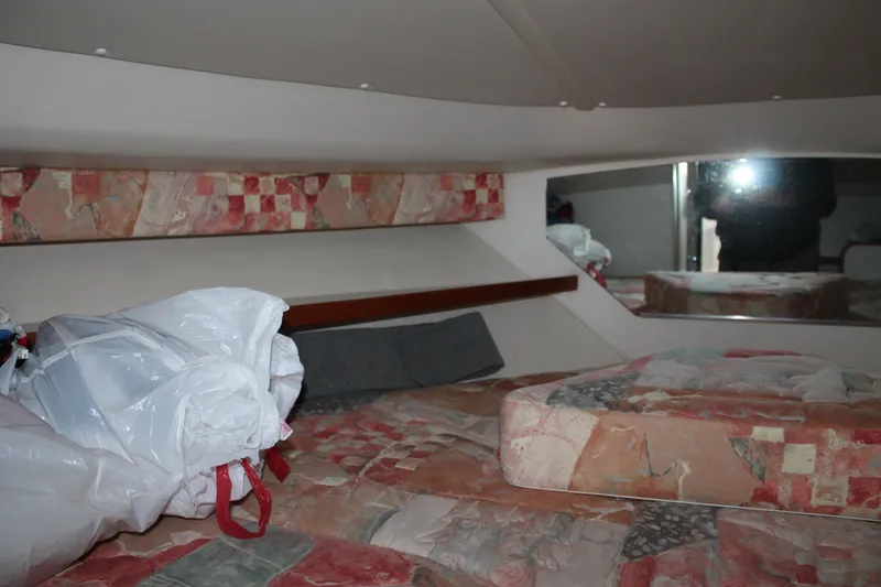 Slide: The Image of 1998 Tiara Yachts 2900 Coronet cabin interior with patterned upholstery and storage items. - 20