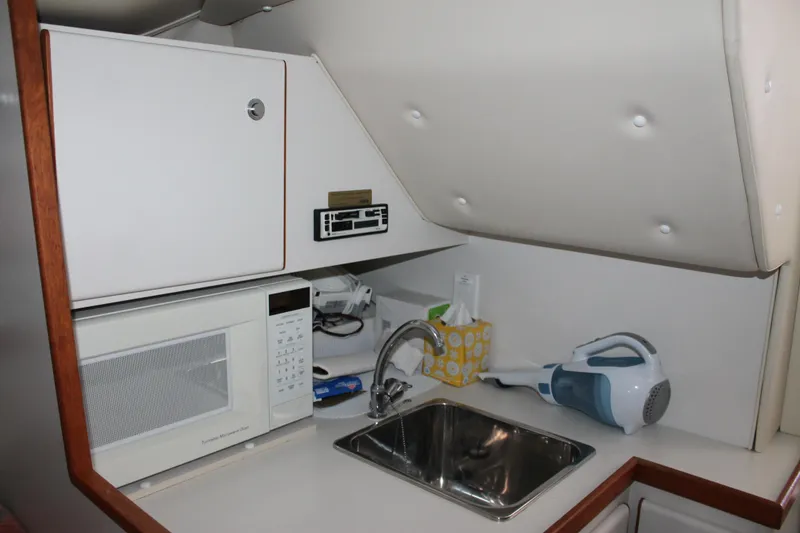 Slide: The Image of Compact kitchenette in a 1998 Tiara Yachts 2900 Coronet with microwave and sink. - 22