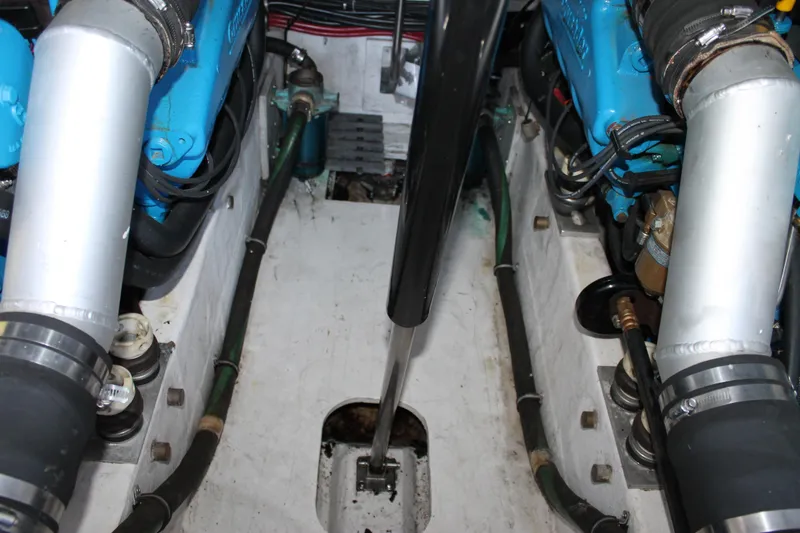 Slide: The Image of Engine compartment of a 1998 Tiara Yachts 2900 Coronet, showcasing dual blue engines. - 24