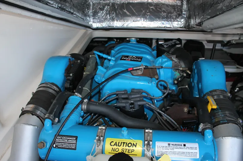 Slide: The Image of Engine compartment of a 1998 Tiara Yachts 2900 Coronet, featuring a blue marine engine. - 25