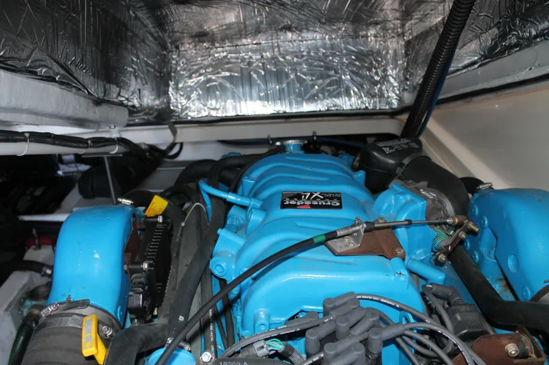 Slide: The Image of Engine compartment of a 1998 Tiara Yachts 2900 Coronet with blue engine components. - 26