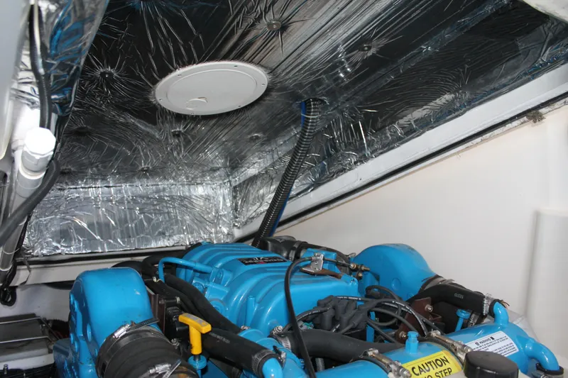 Slide: The Image of Engine compartment of a 1998 Tiara Yachts 2900 Coronet with blue engine components. - 27